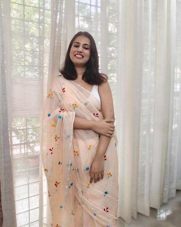 Woman wearing Bela from Phulwari Bazaar beige muslin mulmul saree with floral embroidery, perfect for casual and everyday wear