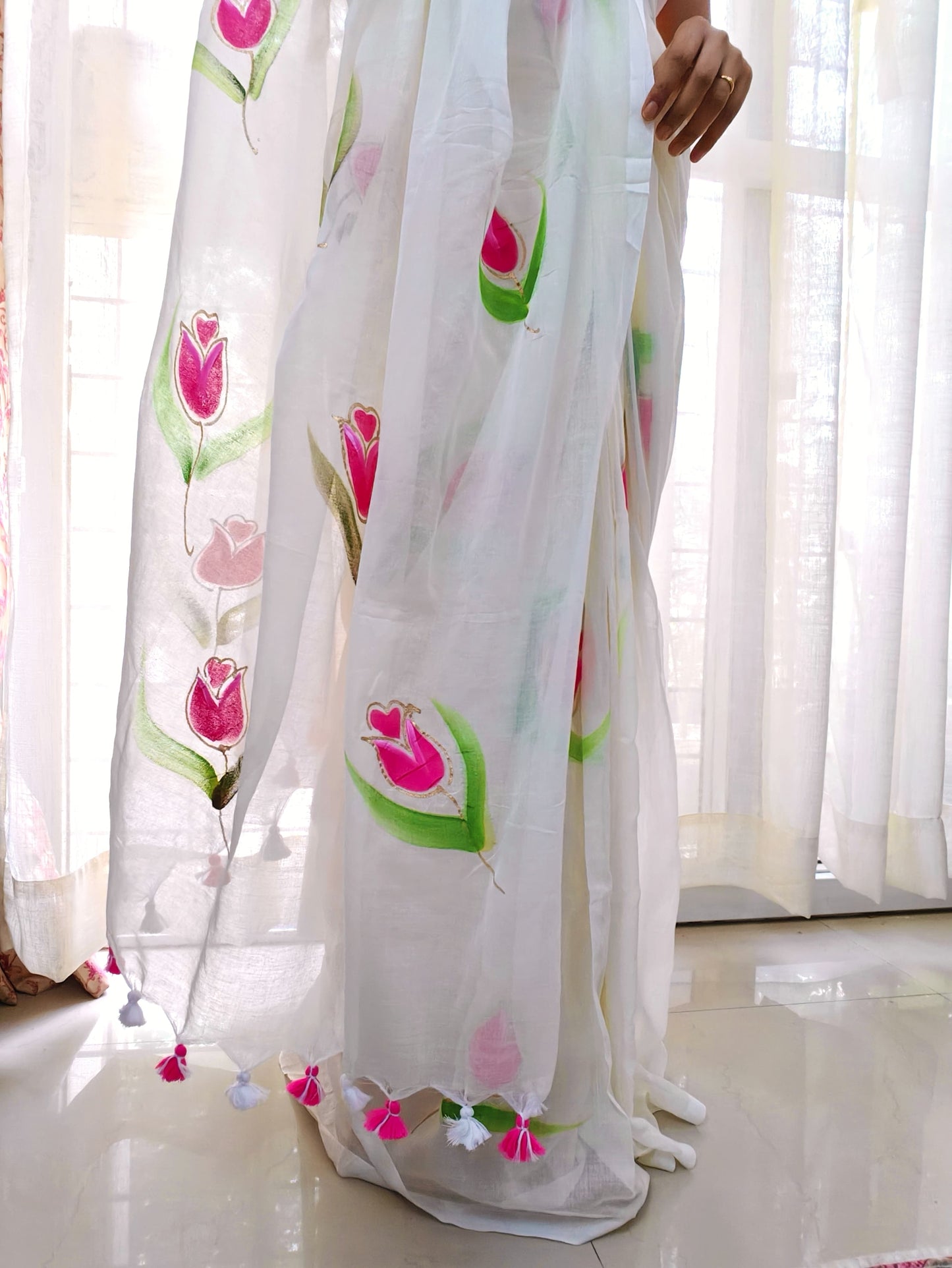 Phulwari Bazaar white mulmul cotton saree with hand-painted pink floral motifs and green leaves, lightweight plain saree perfect for summer wear.