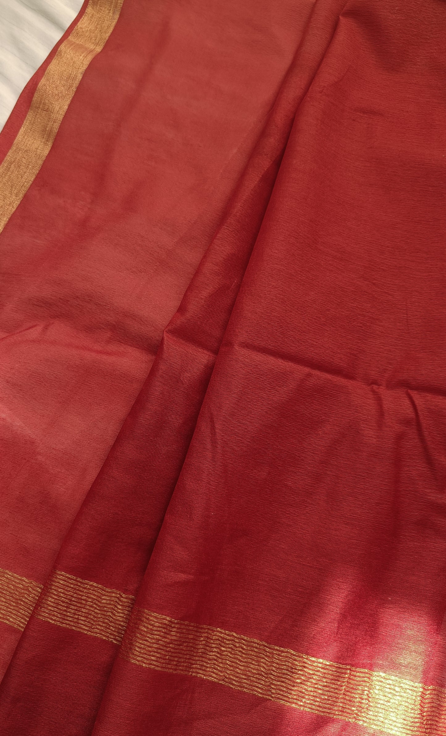 Elegant pallu of Cherry Bomb saree featuring rich gold zari detailing and tassel accents, available at Phulwari Bazaar.