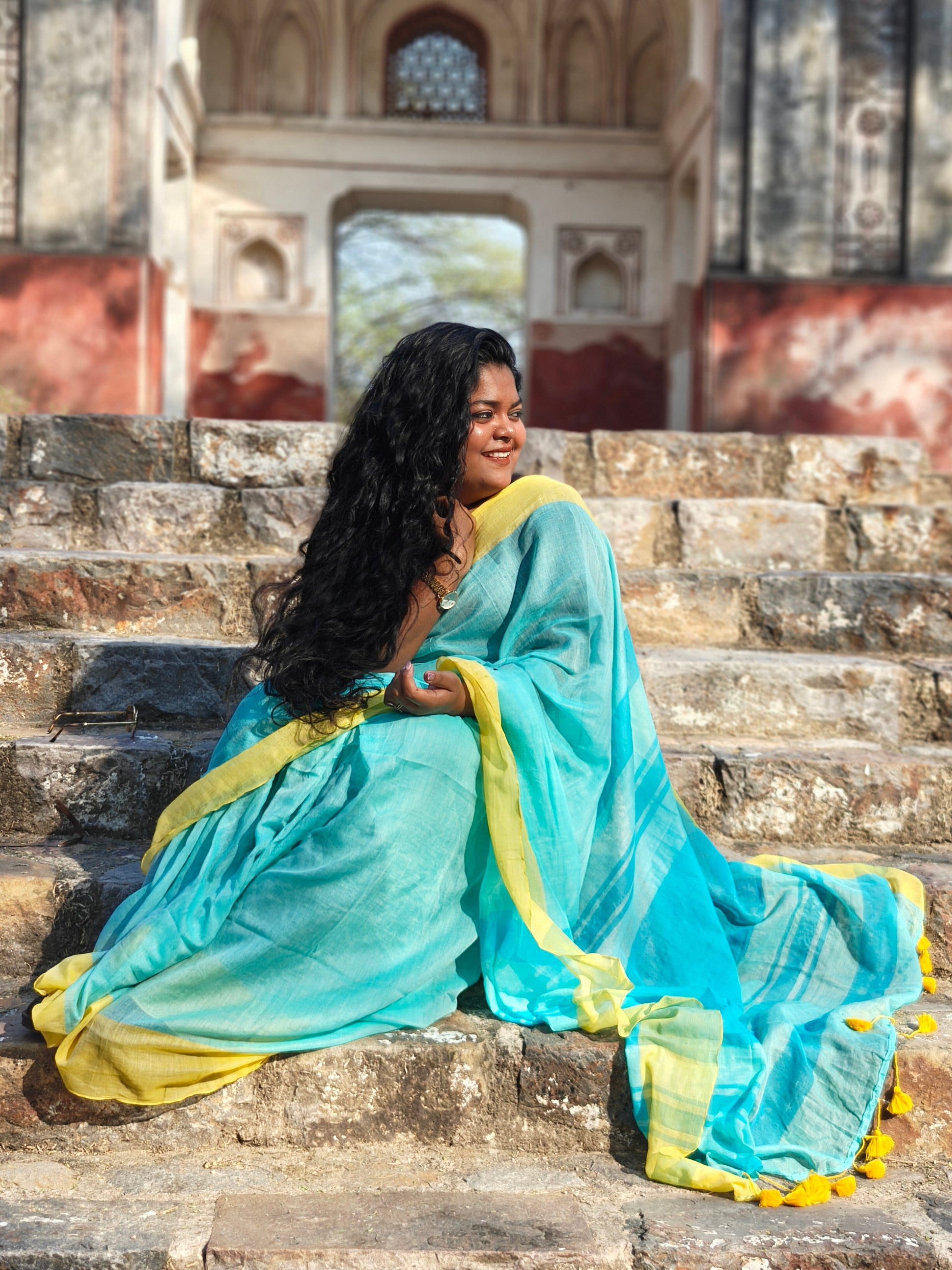 Organic cotton saree in ferozi blue with yellow tassels – perfect for casual wear. Phulwari Bazaar| 
 Phulwari Bazar