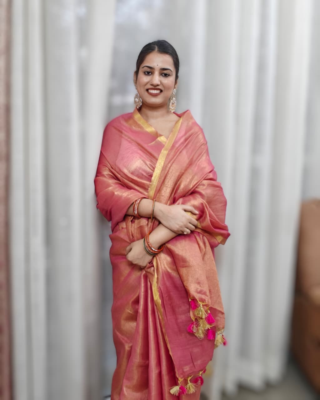 Phulwari Bazaar festive minimal saree in peach with gold zari border and tassels.