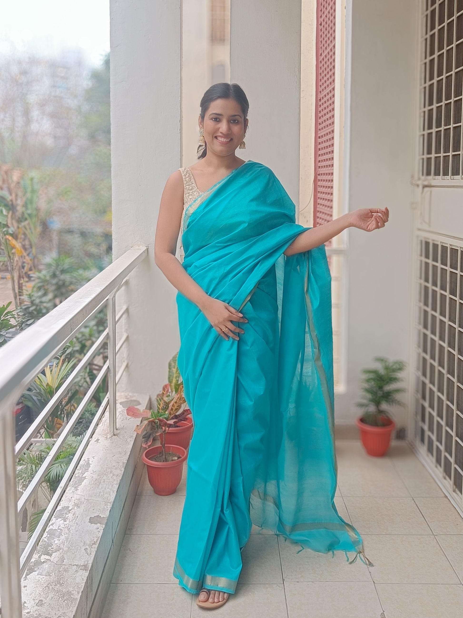 Turquoise Temptation saree in Chanderi cotton silk with gold zari border and pallu, vibrant turquoise blue, tassels, perfect for chic brunches and glamorous evening wear - Phulwari Bazaar.