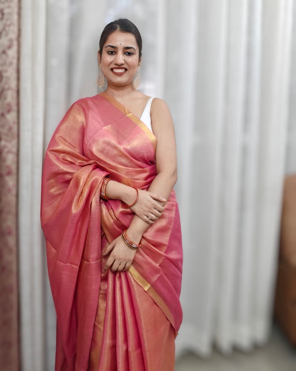 Phulwari Bazaar peach tissue linen handloom saree with golden shimmer and zari border.