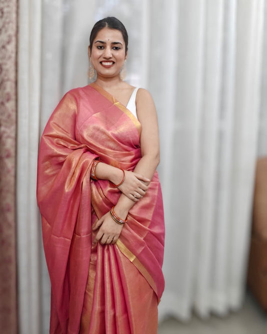 Phulwari Bazaar peach tissue linen handloom saree with golden shimmer and zari border.