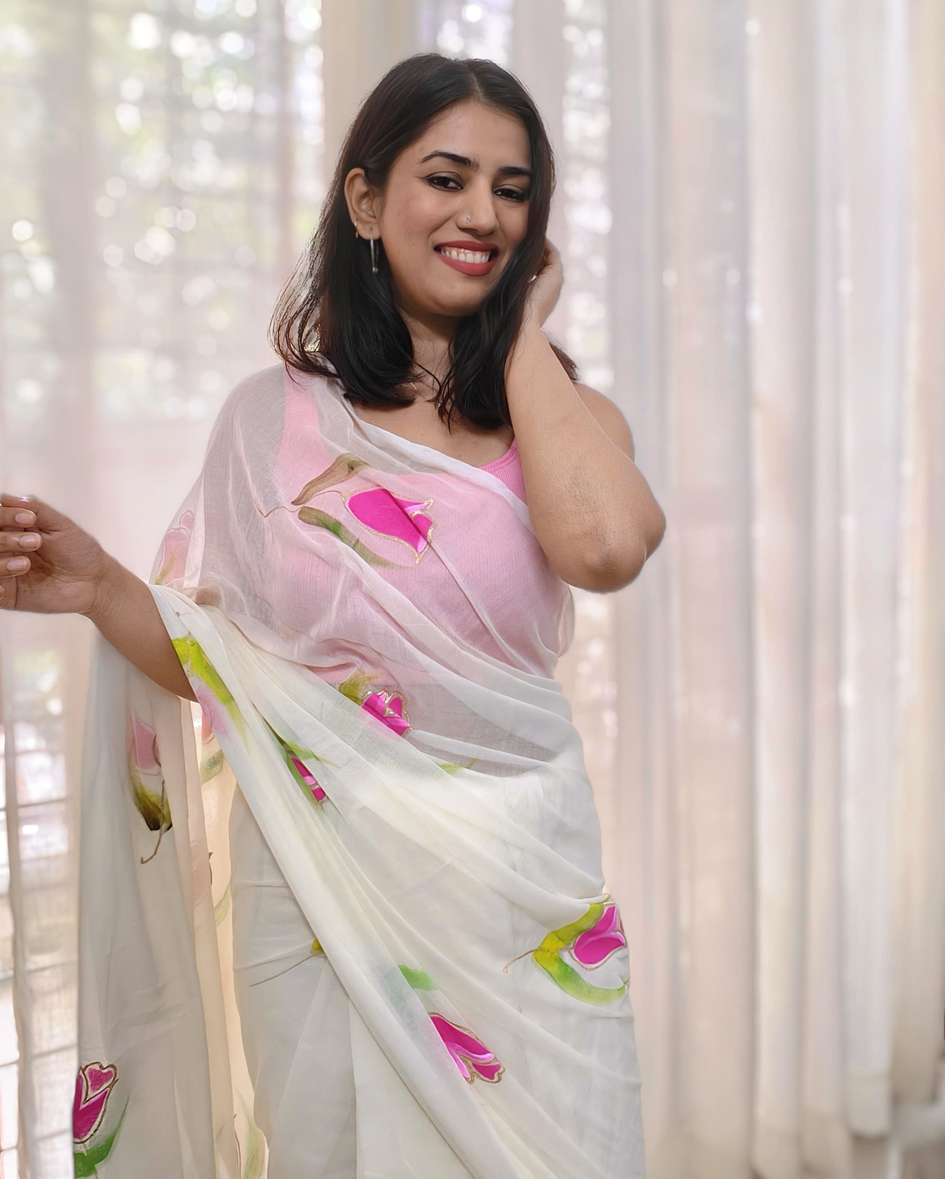 Phulwari Bazaar white saree – plain airy mulmul saree with pastel hand-painted pink florals, soft lightweight cotton summer saree from Bengal.