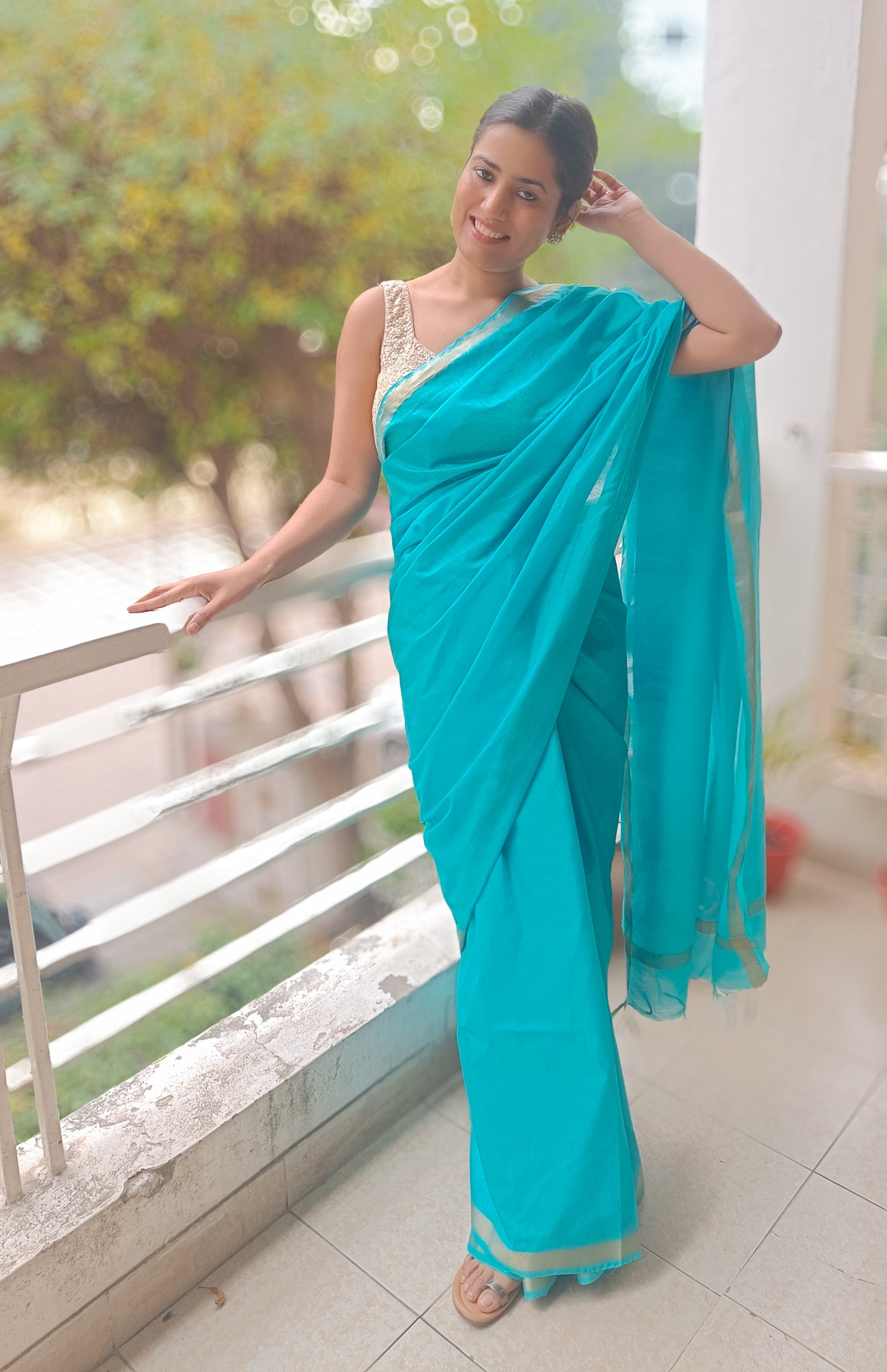 Chanderi cotton silk Turquoise Temptation saree with tassels and gold zari accents.