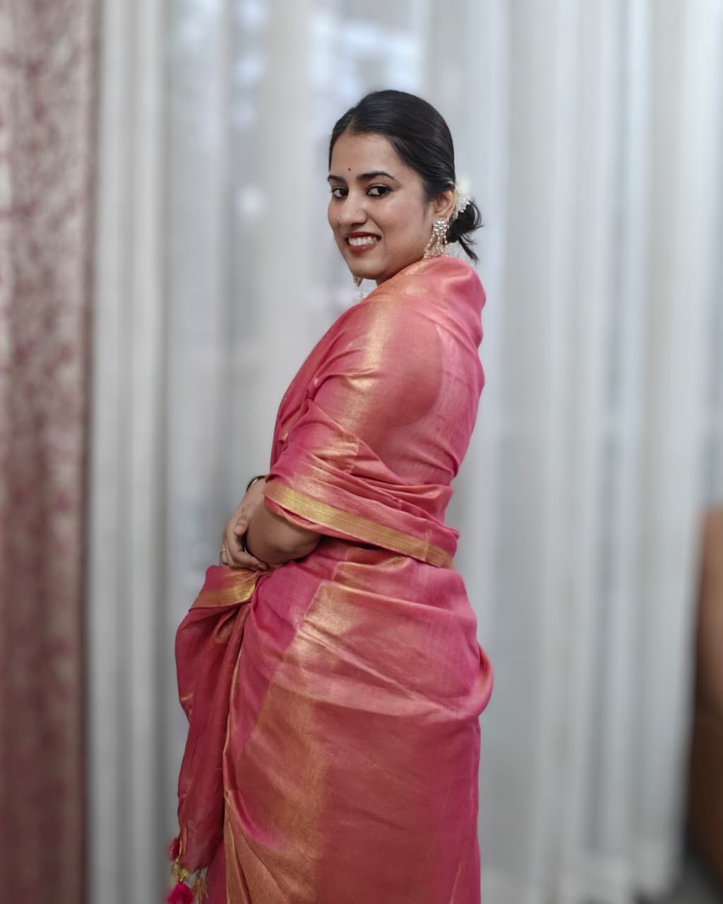 Phulwari Bazaar lightweight handloom linen saree in peach and gold for festive wear.