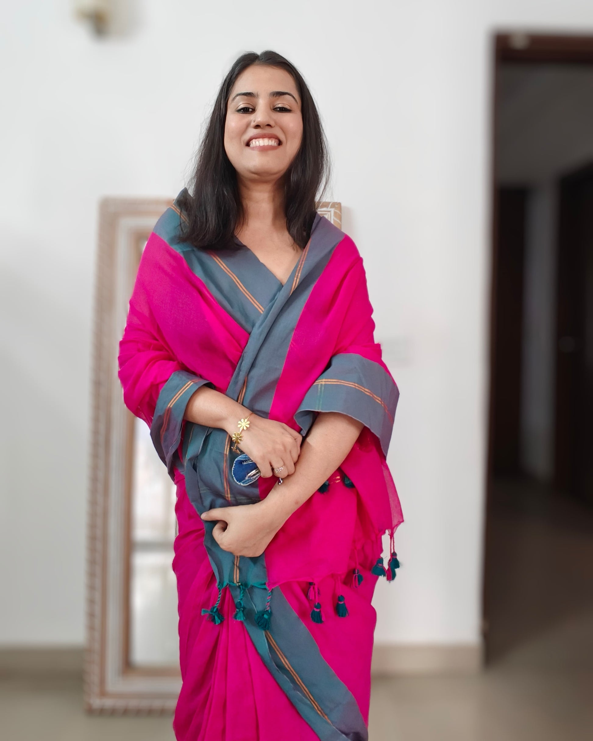 Woman wearing Mala rani pink mulmul cotton saree from Phulwari Bazaar with contrasting border, perfect for everyday wear or light festive occasions
