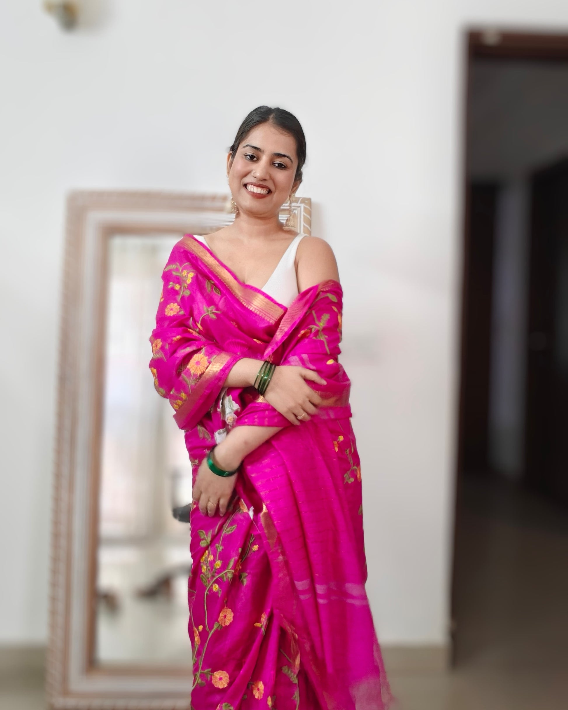 Woman wearing Rani pink pure mulberry silk saree from Phulwari Bazaar with floral embroidery, ideal for weddings and festive celebrations