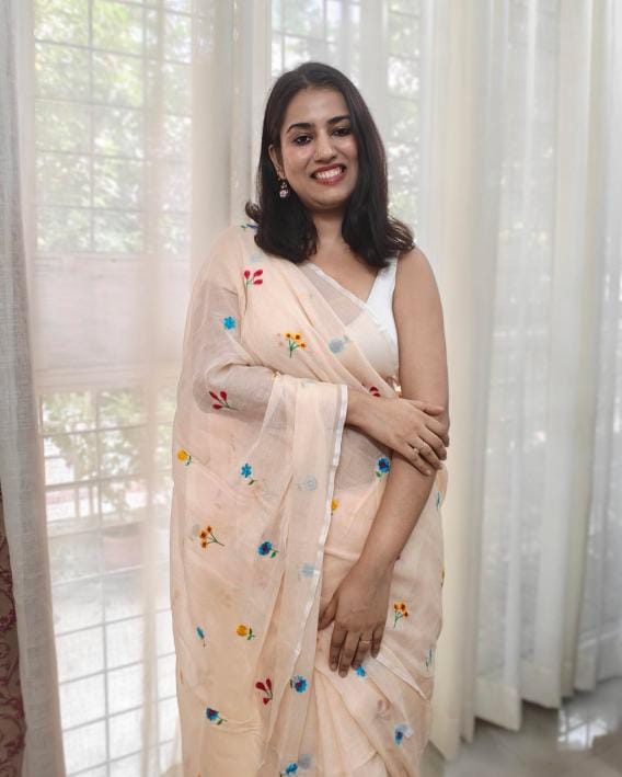 Delicate floral embroidery detail on Bela muslin mulmul saree in soft beige, from Phulwari Bazaar